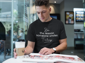 man-wearing-a-round-neck-tee-mockup-while-reading-a-magazine-a17855.png